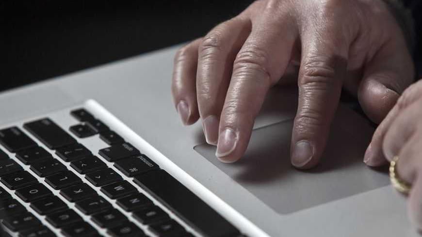 John Bumgarner, a cyber warfare expert who is chief technology officer of the U.S. Cyber Consequences Unit, a non-profit group that studies the impact of cyber threats, works on his laptop computer during a portrait session in Charlotte, North Carolina December 1, 2011. A cyber warfare expert claims he has linked the Stuxnet computer virus that attacked Iran's nuclear program in 2010 to Conficker, a mysterious worm that surfaced in late 2008 and infected millions of PCs. Conficker was used to open back door