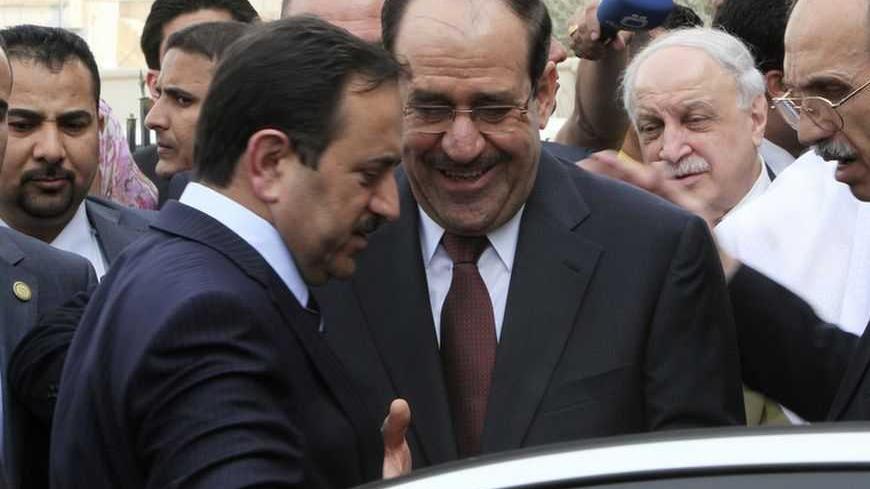 Iraqi Prime Minister Nuri al-Maliki (C) leaves after an Arab economy, finance and trade ministers meeting as part of the Arab League Summit in Baghdad March 27, 2012. The Arab leaders will meet on March 29 in Baghdad for the 23rd Arab League Summit. REUTERS/Ali Haider/Pool (IRAQ - Tags: POLITICS)