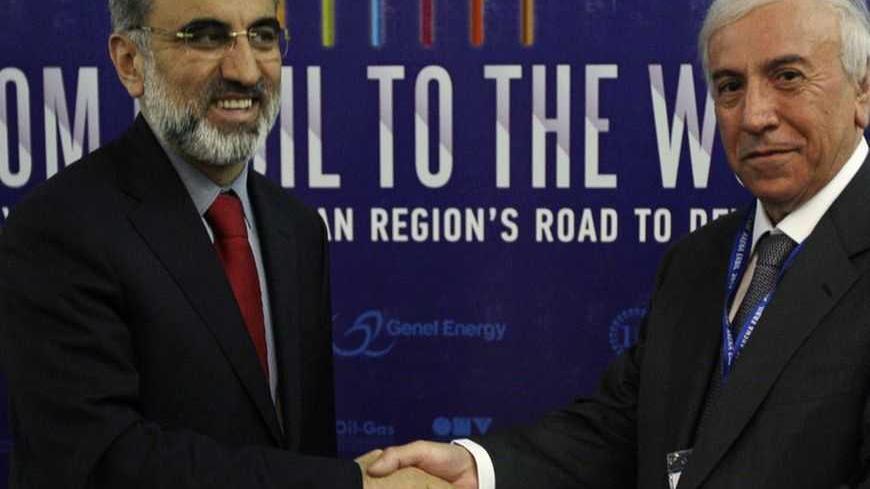 Kurdistan Regional Government Natural Resources Minister Ashti Hawrami (R) shakes hands with Turkey's Energy Minister Taner Yildiz during a joint news conference in Arbil, about 350 km (217 miles) north of Baghdad, May 20,2012.  Iraq's autonomous Kurdistan region expects to start exporting oil from its fields along a new pipeline to the Turkish border when the line is complete in August 2013, Hawrami said on Sunday.   REUTERS/Azad Lashkari (IRAQ - Tags: ENERGY POLITICS)