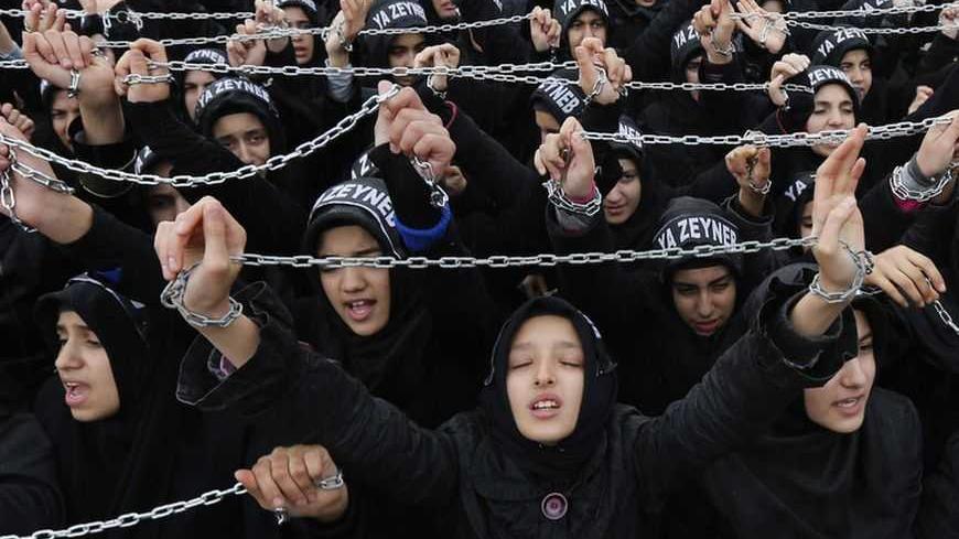 Turkish Shi'ite women shout Islamic slogans as they mourn during an Ashura procession in Istanbul November 24, 2012. Muslims all over the world mourn the slaying of Imam Hussein during the first ten days of the Islamic month of Muharram. Imam Hussein was killed by his political rivals along with 72 companions in the seventh century battle of Kerbala.  REUTERS/Murad Sezer (TURKEY - Tags: ANNIVERSARY RELIGION CIVIL UNREST)