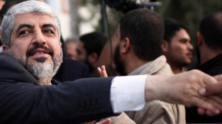 Hamas chief Khaled Meshaal shakes hands with a man as he leaves the Rafah border crossing in the southern Gaza Strip December 10, 2012. Hamas leader Meshaal ended his first visit to the Gaza Strip on Monday with a pledge his Islamist movement would strive to heal political rifts with Palestinian rivals who hold sway in the occupied West Bank. REUTERS/Ahmed Jadallah (GAZA - Tags: POLITICS) - RTR3BF9S