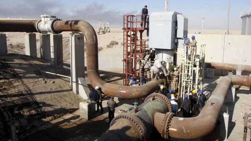 Employees of the state-run South Oil Company (SOC) join a new oil storage tank to the oil pipelines near the southern city of Basra January 14, 2013. The head of the state-run South Oil Company said the new facility will add a capacity of one million barrels to the existing 5.5 million barrels available. REUTERS/Atef Hassan (IRAQ - Tags: ENERGY CIVIL UNREST)