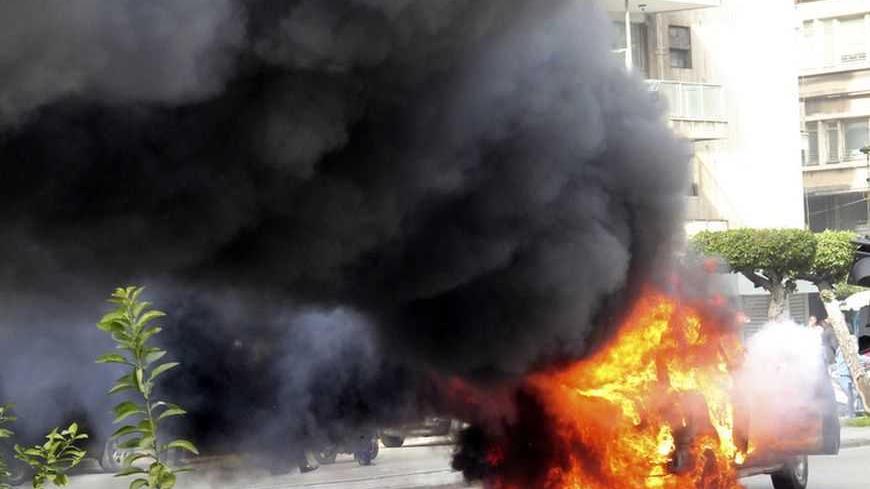 A burning car, which was part of Lebanese Minister of Sports and Youth Faisal Karami's convoy, is seen after it was ambushed by gunmen in the northern city of Tripoli January 18, 2013. Gunmen ambushed the convoy in Tripoli on Friday, wounding three people and riddling a security patrol car with bullets, medics and witnesses said. Karami, appeared to be unhurt, the medics said. REUTERS/Stringer (LEBANON - Tags: POLITICS CIVIL UNREST)