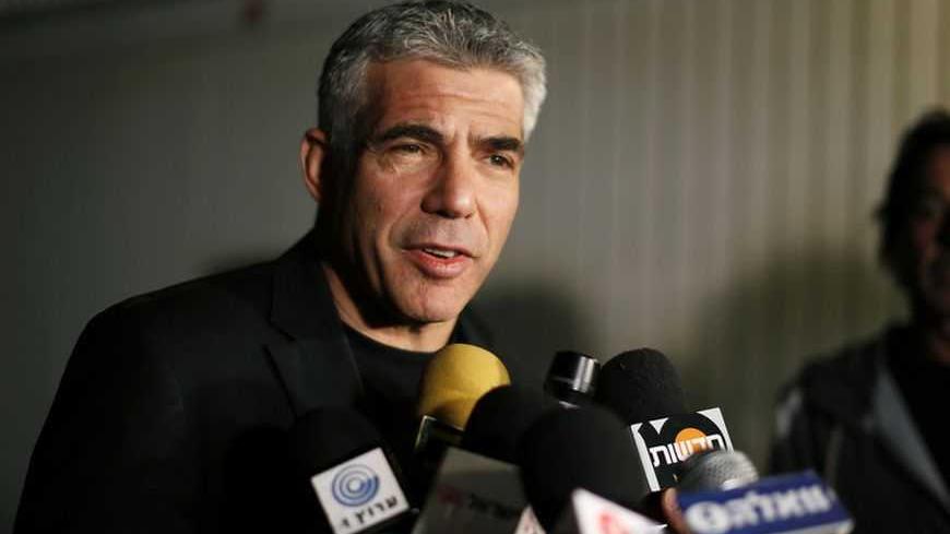 Yair Lapid, leader of the Yesh Atid (There's a Future) party, speaks to members of the media outside his home in Tel Aviv January 23, 2013. Lapid, a former television news anchor whose new centrist party stormed to second place in Israel's election, may well be the kingmaker holding the keys to the next coalition government. REUTERS/Amir Cohen (ISRAEL - Tags: POLITICS ELECTIONS)