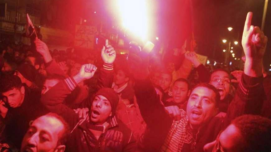 Protesters opposing Egyptian President Mohamed Mursi shout slogans as they march despite a nighttime curfew in the city of Suez January 28, 2013. Egyptian protesters defied a nighttime curfew in restive towns along the Suez Canal, attacking police stations and ignoring emergency rule imposed by Islamist President Mohamed Mursi to end days of clashes that have killed at least 52 people. Egypt's army chief said political strife was pushing the state to the brink of collapse - a stark warning from the institut