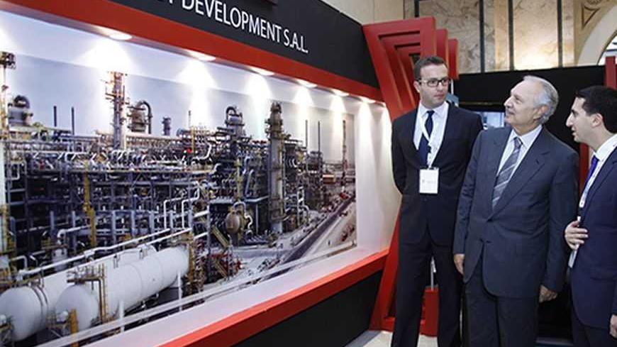 Lebanese Finance Minister Mohammed Safadi (C) tours the stands displayed at an exhibition at the Lebanon International Oil and Gas Summit in Beirut December 3, 2012. REUTERS/Mohamed Azakir (LEBANON - Tags: ENERGY BUSINESS POLITICS)