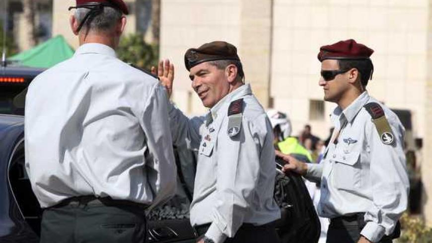 Outgoing Lieutenant-General Gabi Ashkenazi (C) waves to soldiers as he leaves after a handover ceremony in which he was replaced by the new Chief of Staff Lieutenant-General Benny Gantz (L) at the Kirya base in Tel Aviv February 14, 2011. REUTERS/Baz Ratner (ISRAEL - Tags: POLITICS MILITARY)