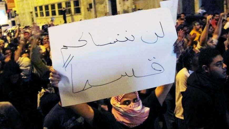 Protesters chant slogans and hold posters during a protest in Qatif March 9, 2011. Saudi Shi'ites staged another small protest in the kingdom's eastern province on Wednesday, defying a ban on demonstrations. More than 100 mostly young men gathered in the main Shi'ite city of Qatif on the Gulf coast to demand the release of prisoners they say are held without trial, witnesses said. Banner "Swear, will never forget you". REUTERS/Stringer (SAUDI ARABIA - Tags: POLITICS CIVIL UNREST)