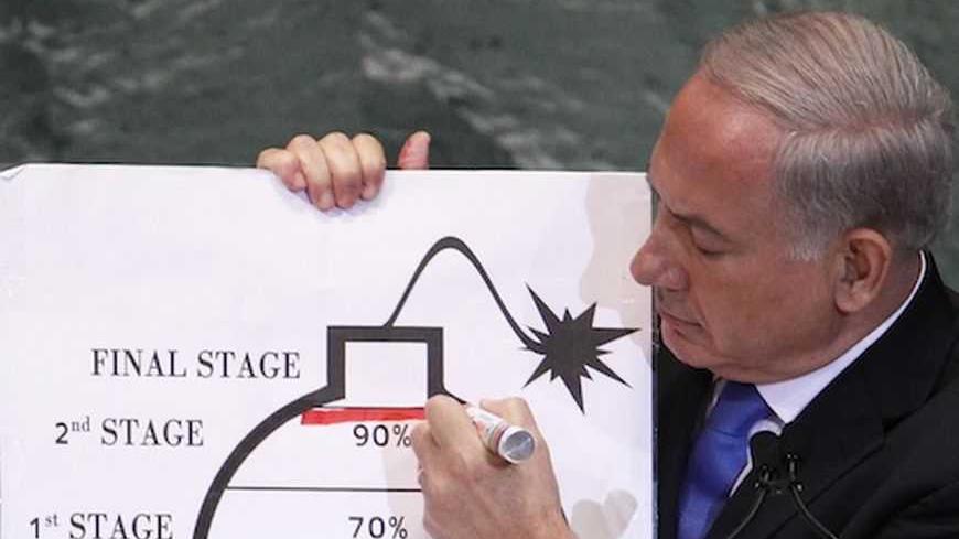Israel's Prime Minister Benjamin Netanyahu draws a red line on the graphic of a bomb used to represent Iran's nuclear program as he addresses the 67th United Nations General Assembly at the U.N. Headquarters in New York, September 27, 2012. The red line he drew represents a point where he believes, the international community should tell Iran that they will not be allowed to pass without intervention. REUTERS/Lucas Jackson (UNITED STATES - Tags: POLITICS) - RTR38I7P