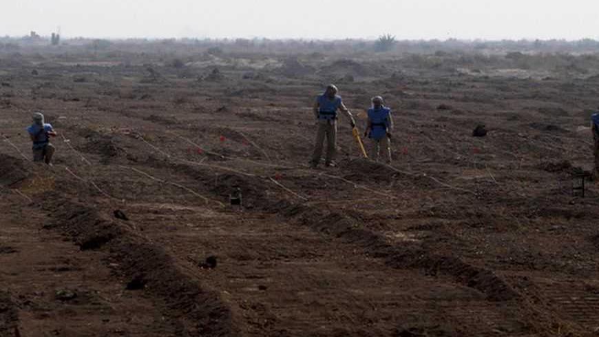Members of the Iraqi Mine and Unexploded Ordnance Clearance Organization (IMCO) work to find mines in the Shatt-al-Arab district, in Iraq's southern city of Basra, November 6, 2012. Decades of war have left Iraq with one of the worst mine problems in the world, according to UNICEF, with around 20 million anti-personnel mines and more than 50 million cluster bombs believed to be left over in border areas and southern oilfields. Iraq's Environment Ministry says there are 25 million landmines scattered around 