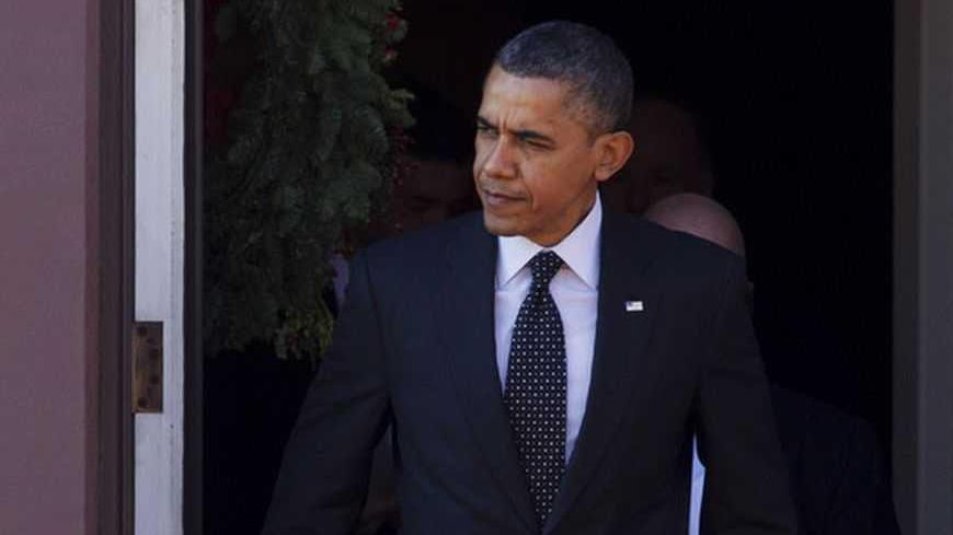 U.S. President Barack Obama departs the Blair House for the White House, after attending a Christmas party hosted by the National Security Council in Washington, December 13, 2012. REUTERS/Jason Reed (UNITED STATES - Tags: POLITICS)
