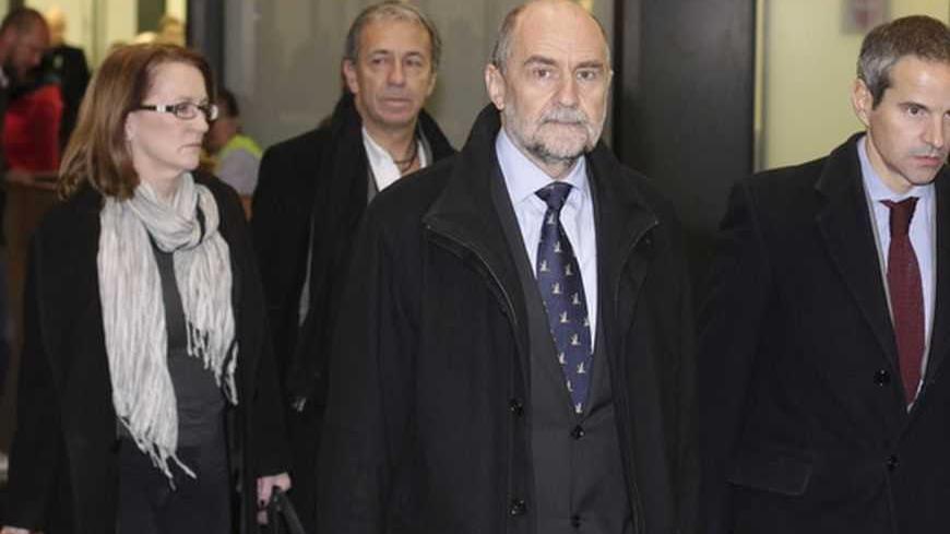 Herman Nackaerts (C), head of a delegation of the International Atomic Energy Agency (IAEA), reacts at the airport in Vienna after arriving with his team from Iran December 14, 2012. Some progress is believed to have been made in Thursday's talks between the U.N. nuclear agency and Iran in Tehran, a diplomatic source said on Friday. The source, who declined to be identified because of the sensitivity of the discussions, said a new meeting between Iran and the U.N. IAEA was expected to take place in mid-Janu