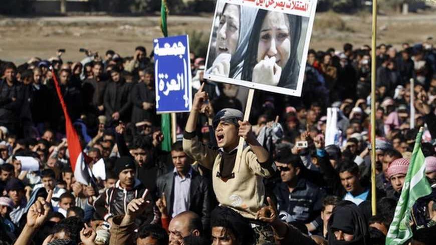 Iraqi Sunni Muslims take part in an anti-government demonstration in Falluja, 50 km (30 miles) west of Baghdad, December 28, 2012. Tens of thousands of protesters from Iraq's Sunni Muslim minority poured onto the streets after Friday prayers in a show of force against Shi'ite Prime Minister Nuri al-Maliki, keeping up a week-old blockade of a highway. Around 60,000 people blocked the main road through the city of Falluja, setting fire to the Iranian flag and shouting "out, out Iran! Baghdad stays free" and "