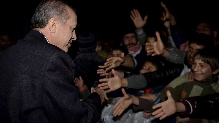 Turkish Prime Minister Tayyip Erdogan shakes hands with Syrian refugees as he visits a refugee camp near Akcakale border crossing on the Turkish-Syrian border, southern Sanliurfa province, December 30, 2012. REUTERS/Kayhan Ozer/Prime Minister's Press Office/Handout (TURKEY - Tags: POLITICS CONFLICT) FOR EDITORIAL USE ONLY. NOT FOR SALE FOR MARKETING OR ADVERTISING CAMPAIGNS. THIS IMAGE HAS BEEN SUPPLIED BY A THIRD PARTY. IT IS DISTRIBUTED, EXACTLY AS RECEIVED BY REUTERS, AS A SERVICE TO CLIENTS - RTR3BZG7