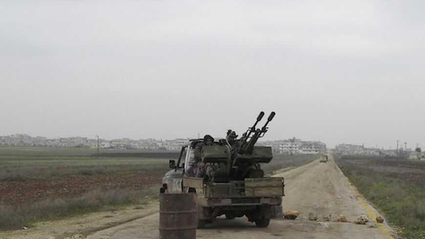 Fighters from the Islamist Syrian rebel group Jabhat al-Nusra sit in their tank near Taftanaz military airport January 12, 2013. Picture taken January 12, 2013.REUTERS/Abdalghne Karoof (SYRIA - Tags: CIVIL UNREST MILITARY POLITICS CONFLICT) - RTR3CFWU