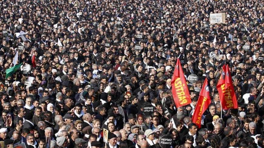 Thousands attend the funeral ceremony of the three Kurdish activists shot in Paris, in Diyarbakir, the largest city in Turkey's mainly Kurdish southeast, January 17, 2013. The bodies of the activists, including that of Kurdistan Workers Party (PKK) co-founder Sakine Cansiz, arrived by plane on Wednesday evening in Diyarbakir. REUTERS/Umit Bektas (TURKEY - Tags: POLITICS OBITUARY CIVIL UNREST)