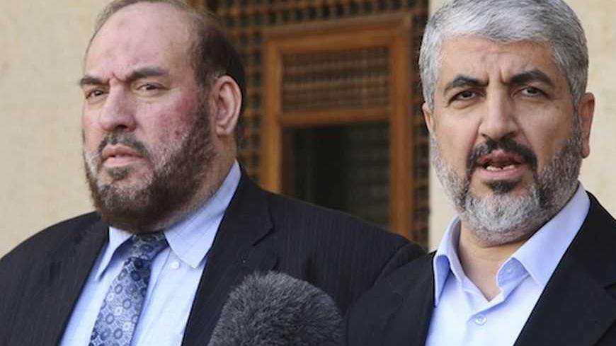 Hamas leader Khaled Meshaal (R) and Mohammad Nazzal, a member of the Hamas leadership, speak to media after their meeting with Jordan's King Abdullah at the Royal Palace in Amman January 28, 2013.  REUTERS/Majed Jaber (JORDAN - Tags: POLITICS) - RTR3D30A