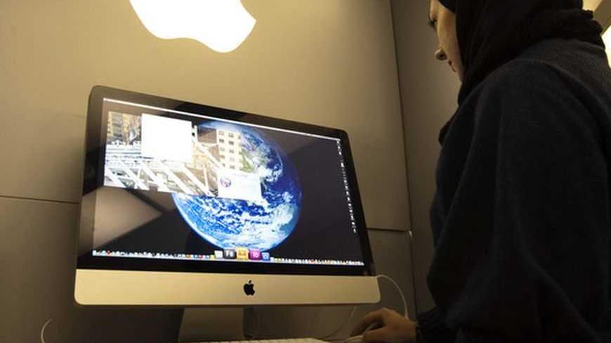 EDITORS' NOTE: Reuters and other foreign media are subject to Iranian restrictions on leaving the office to report, film or take pictures in Tehran.
A woman uses an iMac computer in a shop at a mobile and computer shopping complex in northern Tehran January 18, 2011. Although there were no queues outside Tehran's computer stores when Apple's iPad hit the market last year, the latest must-have gadget has quietly appeared in shops, despite tightened economic sanctions. On a recent cold winter's evening, th