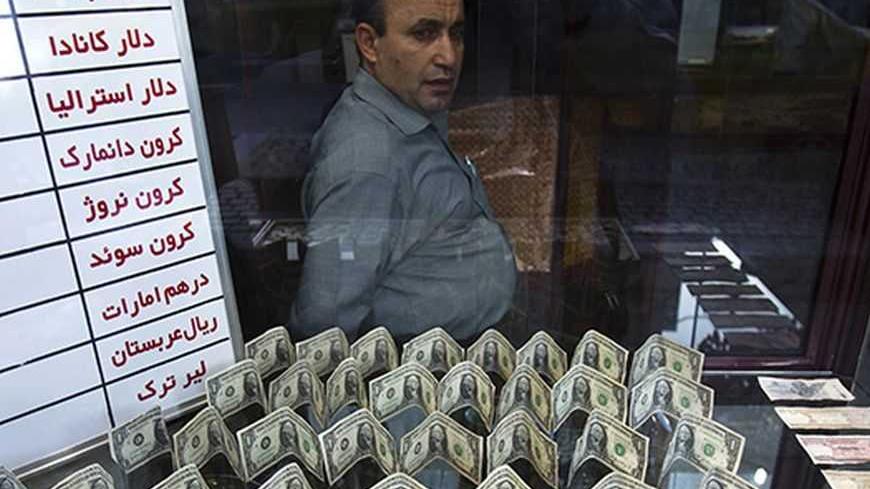 EDITORS' NOTE: Reuters and other foreign media are subject to Iranian restrictions on leaving the office to report, film or take pictures in Tehran.

An exchange currency dealer sits at his shop as he waits for customer in Tehran's business district October 24, 2011. Iranian media reported last week that monetary authorities had reversed a six-month-old decision to cut interest on bank deposits, aiming to mop up excess cash in the economy and halt a dangerous rise of inflation. The news made sense to econom