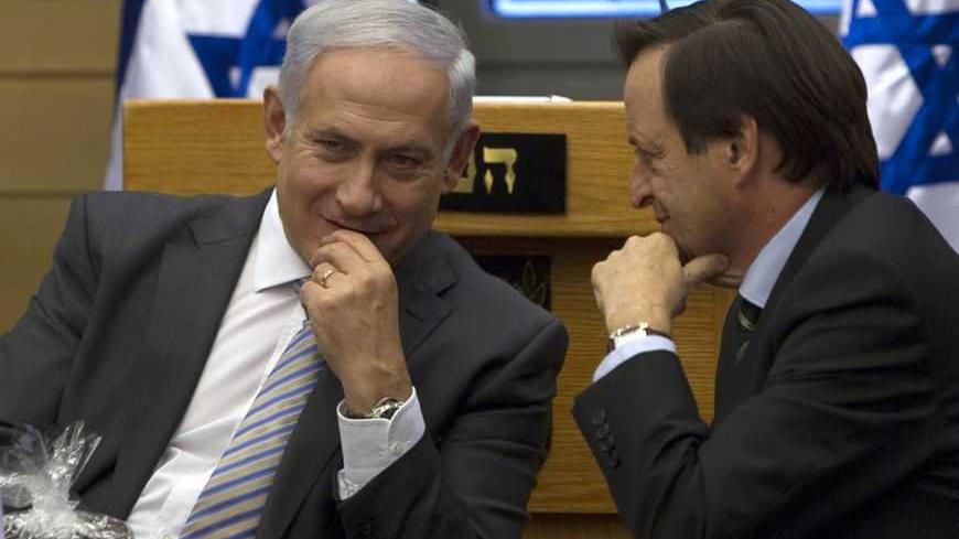 Israel's Prime Minister Benjamin Netanyahu (L) speaks with Deputy Prime Minister Dan Meridor during a Likud party meeting at the Knesset, the Israeli parliament, in Jerusalem September 20, 2011. Netanyahu leaves for New York on Wednesday to address the United Nations where Palestinian President Mahmoud Abbas is pursuing a bid for full U.N. membership for a Palestinian state.    REUTERS/Darren Whiteside (JERUSALEM - Tags: POLITICS) - RTR2RL9O