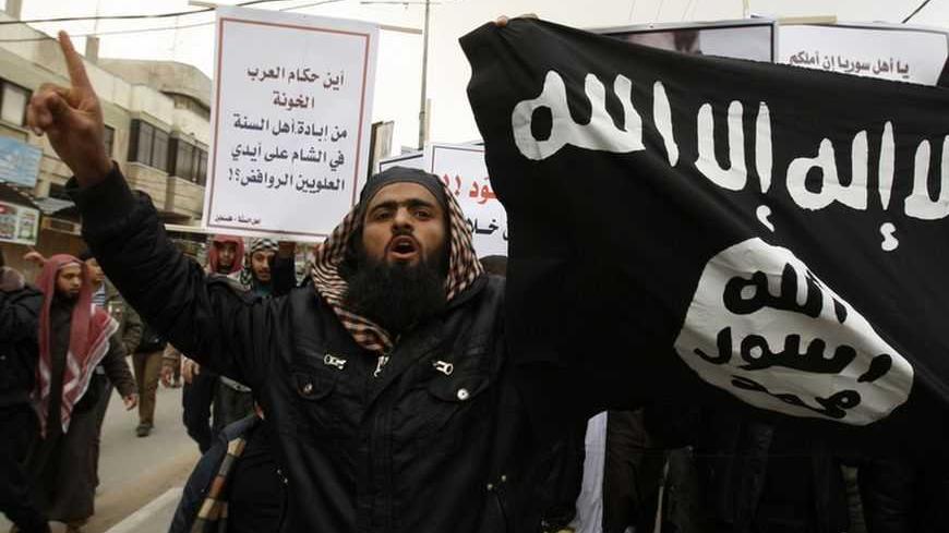 Palestinian Salafists take part in a protest against Syria's President Bashar al-Assad in Rafah in the southern Gaza Strip February 24, 2012. The black flag reads "There is no god but Allah and Mohammad is the prophet". The white sign reads "Where are the traitor Arab rulers". REUTERS/Ibraheem Abu Mustafa (GAZA - Tags: POLITICS CIVIL UNREST) - RTR2YDGR