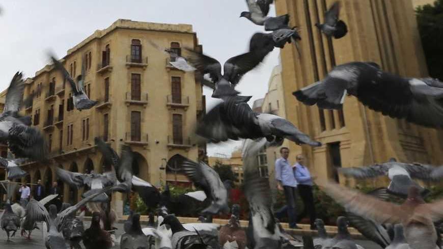 Pigeons fly in front of the parliament square in downtown Beirut October 25, 2012. The party capital of the Arab world, Beirut is a freewheeling city where Gulf Arabs, expatriates and Lebanese emigres fly in to enjoy its luxury hotels. But under the veneer of modernity lie sectarian demons coiled to strike. The car-bomb assassination last Friday of intelligence chief Wissam al-Hassan - an attack almost universally blamed on Syria and its local allies - brought the merry-go-round to a juddering halt. Gunmen 