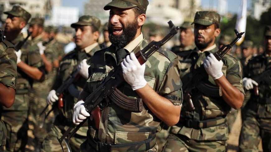 Members of Hamas' national security forces march during a graduation ceremony at their destroyed security compound in Gaza City December 2, 2012. The compound was destroyed during the eight days of Israeli air strikes on Gaza and cross-border Palestinian rocket attacks that ended in an Egyptian-brokered truce agreement last month calling on Israel to ease restrictions on the territory.      REUTERS/Suhaib Salem (GAZA - Tags: CIVIL UNREST CONFLICT) - RTR3B4J6