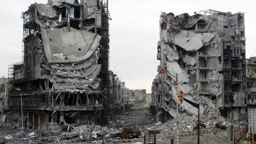 Destroyed buildings are seen on a deserted street in Homs January 30, 2013. At least 60,000 people have been killed in Syria's civil war. Mostly Sunni Homs, a commercial and agricultural hub 140 km (90 miles) north of Damascus, has been at the heart of the 22-month uprising against Syrian President Bashar al-Assad. Picture taken January 30, 2013. REUTERS/Yazan Homsy  (SYRIA - Tags: POLITICS CIVIL UNREST TPX IMAGES OF THE DAY) - RTR3D6NT