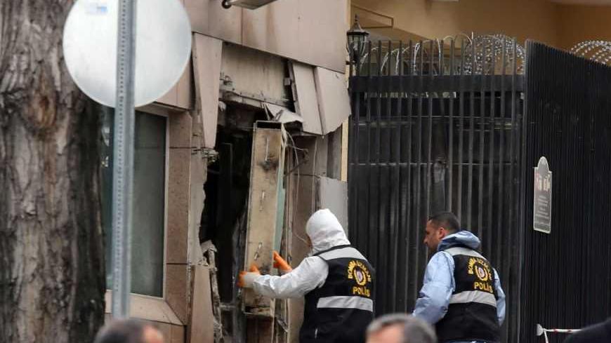 Turkish police bomb experts inspect the site after an explosion at the entrance of the U.S. embassy in Ankara February 1, 2013. A suspected suicide bomber detonated explosives in an attack which killed two people at the U.S. embassy in Ankara on Friday, the provincial governor Alaaddin Yuksel told reporters.  REUTERS/Stringer (TURKEY - Tags: POLITICS CIVIL UNREST) - RTR3D81N