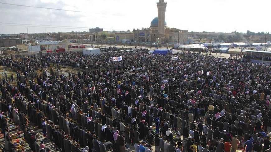 Iraqi Sunni Muslims take part in Friday prayers during an anti-government demonstration in the central city of Samarra February 1, 2013.  Chanting "No" to Iraqi Prime Minister Nuri al-Maliki, tens of thousands of Sunni Muslims protested after Friday prayers in huge rallies against the Shi'ite premier that are raising the spectre of renewed sectarian unrest. REUTERS/Bakr al-Azzawi (IRAQ - Tags: POLITICS CIVIL UNREST) - RTR3D8FX