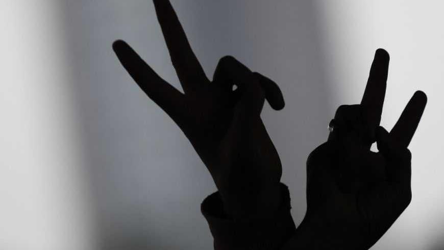 A pro-Kurdish demonstrator gestures during a protest in Istanbul February 15, 2013. Supporters of the pro-Kurdish Peace and Democracy Party (BDP) held a protest to mark the 14th anniversary of the capture of Kurdistan Workers' Party (PKK) leader Abdullah Ocalan. REUTERS/Murad Sezer (TURKEY - Tags: POLITICS CIVIL UNREST) - RTR3DU77