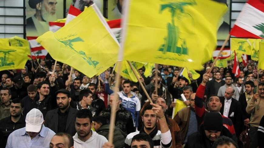 Lebanon's Hezbollah supporters wave flags during a rally to commemorate Martyrs' Day in Beirut, February 16, 2013. REUTERS/Sharif Karim (LEBANON - Tags: POLITICS) - RTR3DVBY