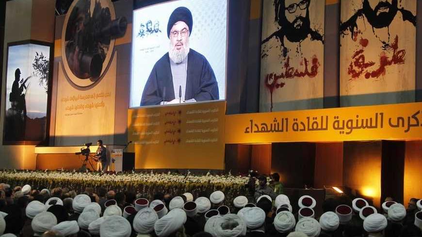 Shi'ite, Sunni Muslim and Druze Lebanese clerics listen to Lebanon's Hezbollah leader Sayyed Hassan Nasrallah addressing his supporters during a rally to commemorate Martyrs' Day in Beirut, February 16, 2013.  REUTERS/Sharif Karim (LEBANON - Tags: POLITICS) - RTR3DVC0