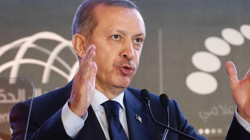Turkish Prime Minister Tayyip Erdogan talks during the opening ceremony of government communication forum in Sharjah, United Arab Emirates February 24, 2013. REUTERS/Ahmed Jadallah (UNITED ARAB EMIRATES - Tags: POLITICS SCIENCE TECHNOLOGY) - RTR3E7DY