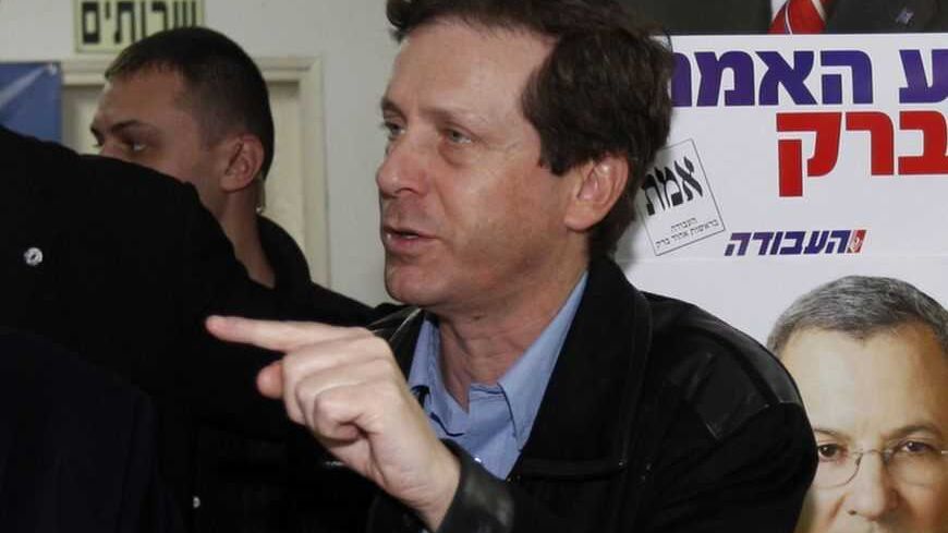 Israel's Defence Minister and Labour party leader Ehud Barak stands with Minister for Welfare and Social Services Isaac Herzog (R) during a visit to party headquarters in Tel Aviv February 10, 2009. Israelis voted on Tuesday in a tight election race, with right-wing opposition leader Benjamin Netanyahu bidding to oust the centrist party of Foreign Minister Tzipi Livni. REUTERS/Gil Cohen Magen (ISRAEL) - RTXBGFP
