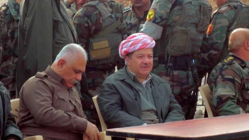 Massud Barzani, the president of Iraq's autonomous Kurdistan region (C-bottom) sits amidst Kurdish peshmerga security forces during a visit to the disputed north Iraq province of Kirkuk on December 10, 2012 on the outskirts of the Kirkuk. The visit may increase already-high tension with Baghdad, which has seen both sides deploy military reinforcements to areas in north Iraq. The dispute over territory in northern Iraq is the biggest threat to the country's long-term stability, diplomats and officials say. T