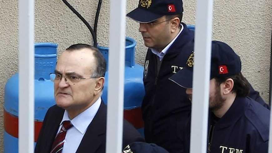 Former deputy Chief of the General Staff General Ergin Saygun (L) is escorted by police officers at a courthouse in Istanbul February 25, 2010. Turkey's political and military leaders meet on Thursday as a storm gathers over a coup plot investigation against the armed forces which is threatening stability and investor confidence in the EU-candidate country. The most senior detainees, retired Air Force Commander Ibrahim Firtina and ex-navy chief Ozden Ornek, are brought to the court for questioning on Thursd