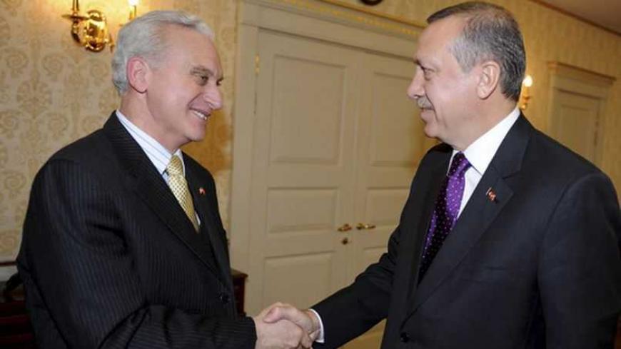 U.S. Ambassador Francis J. Ricciardone (L) shakes hands with Turkey's Prime Minister Tayyip Erdogan before their meeting in Ankara March 11, 2011. REUTERS/Yasin Bulbul/Prime Minister's Press Office/Handout (TURKEY - Tags: POLITICS) FOR EDITORIAL USE ONLY. NOT FOR SALE FOR MARKETING OR ADVERTISING CAMPAIGNS. THIS IMAGE HAS BEEN SUPPLIED BY A THIRD PARTY. IT IS DISTRIBUTED, EXACTLY AS RECEIVED BY REUTERS, AS A SERVICE TO CLIENTS - RTR2JRBJ