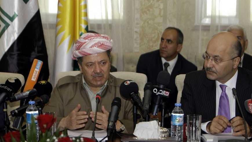 Kurdish Regional Government President Massoud Barzani (C) speaks in a meeting with Kurdish envoys abroad as Prime Minister Barham Salih (R) of Iraq's Kurdistan region looks on in Arbil, about 350 km (220 miles) north of Baghdad September 6, 2011. Speaker of Kurdistan's parliament Kamal Kirkuki is seen on the left.  REUTERS/Azad Lashkari (IRAQ - Tags: POLITICS) - RTR2QV63