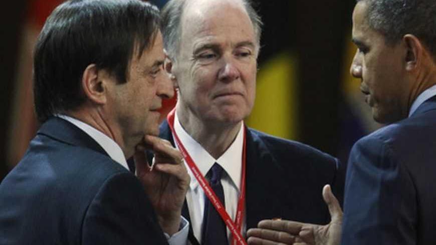 U.S. President Barack Obama (R) speaks to Israel's Deputy Prime Minister Dan Meridor at a plenary session during the Nuclear Security Summit at the Convention and Exhibition Center (COEX) in Seoul March 27, 2012. The man at centre at an unidentified member of the U.S. delegation. REUTERS/Larry Downing (SOUTH KOREA  - Tags: POLITICS MILITARY)   - RTR2ZXN6