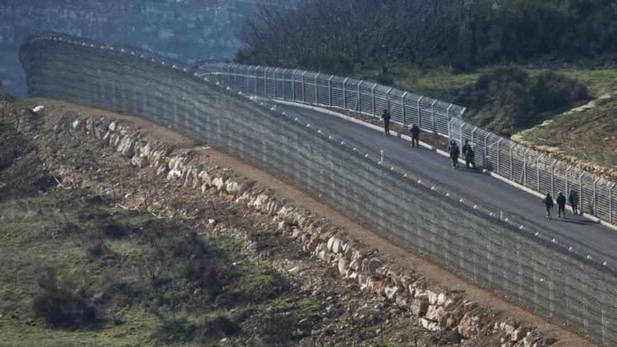 Israeli soldiers patrol in the Syrian-Israeli ceasefire line near the Druze village of Majdal Shams in the Golan Heights March 30, 2012. Israel deployed thousands of extra security forces nationwide on Friday, reinforcing border crossings with Lebanon and Syria and shutting crossings with the occupied West Bank after Palestinian groups announced plans to march on Israel's borders on a day when Israeli Arabs mark "Land Day", the annual commemorations in Israel of the killing by police of six Arab citizens in