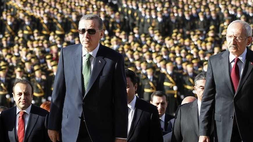 Turkey's Prime Minister Tayyip Erdogan (2nd R) and leader of the main opposition Republican People's Party (CHP) Kemal Kilicdaroglu (R) attend an official ceremony to mark the 89th anniversary of Republic Day at Anitkabir in Ankara October 29, 2012. Anitkabir is the mausoleum of Mustafa Kemal Ataturk, founder of secular Turkey. REUTERS/Umit Bektas (TURKEY - Tags: POLITICS) - RTR39QHB
