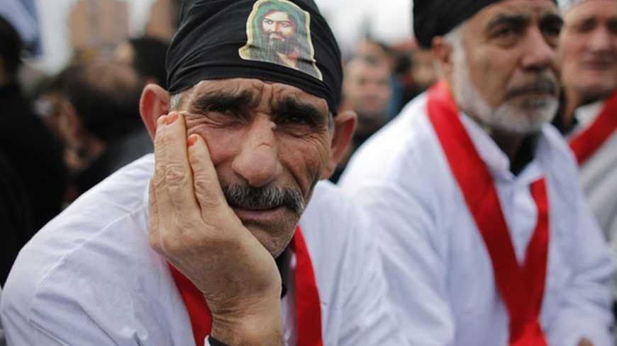 Shi'ite men attend an Ashura procession in Istanbul November 24, 2012. Ashura, the most important day in the Shi'ite calendar, commemorates the death of Imam Hussein, grandson of the Prophet Mohammad, in the seventh century battle of Kerbala. REUTERS/Murad Sezer (TURKEY - Tags: ANNIVERSARY RELIGION) - RTR3ATPL
