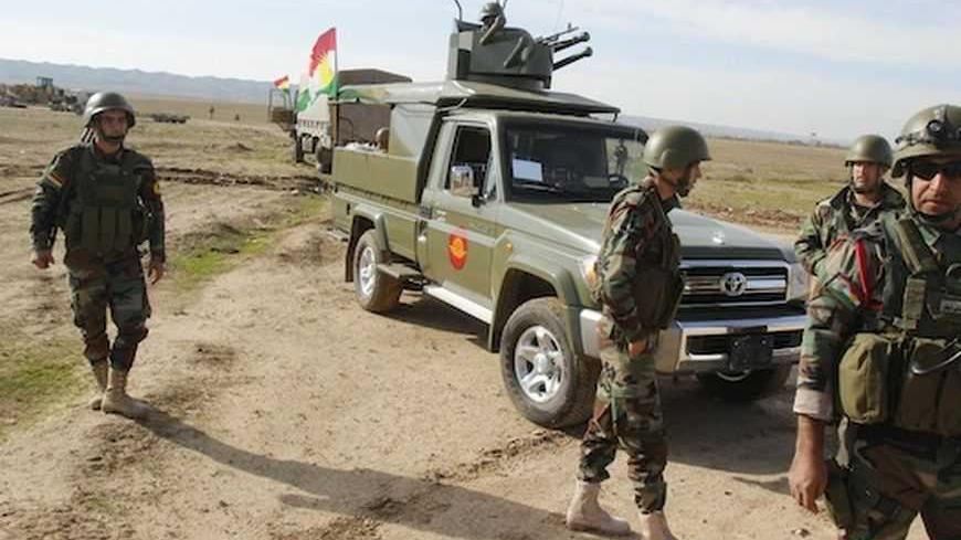 Kurdish Peshmerga troops are deployed on the outskirts of Kirkuk, some 250km (155 miles) north of Baghdad December 3, 2012. Iraq's Kurdish region has sent reinforcements to a disputed area where its troops are involved in a standoff with the Iraqi army, a senior Kurdish military official said, despite calls on both sides for dialogue to calm the situation. Picture taken December 3, 2012. REUTERS/Ako Rasheed (IRAQ - Tags: POLITICS MILITARY CIVIL UNREST) - RTR3B6TV