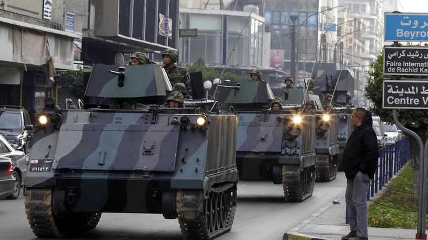 Lebanese Army soldiers deploy after gunmen ambushed the convoy of Lebanese Minister of Sports and Youth Faisal Karami in the northern city of Tripoli January 18, 2013. Gunmen ambushed the convoy in Tripoli on Friday, wounding three people and riddling a security patrol car with bullets, medics and witnesses said. Karami, appeared to be unhurt, the medics said. REUTERS/Mohamed Azakir (LEBANON - Tags: POLITICS CIVIL UNREST) - RTR3CLYJ