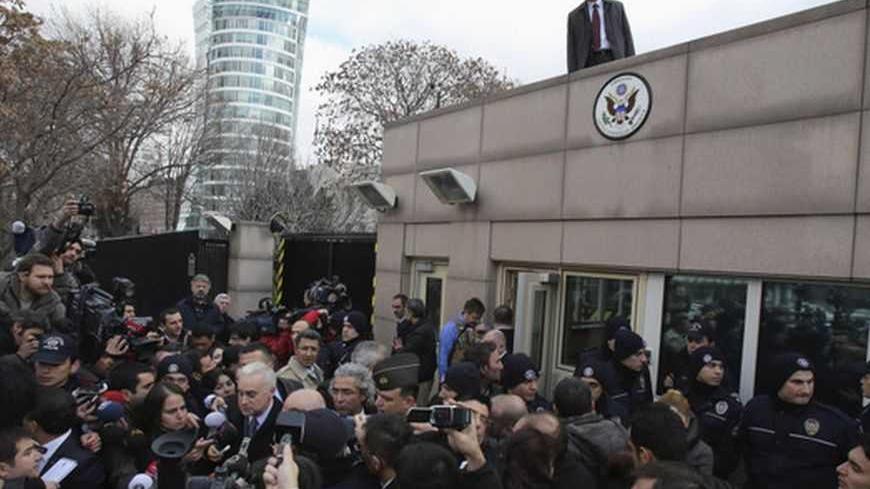 U.S. Ambassador to Turkey Francis Ricciardone (L, with white hair) speaks to media outside of the U.S. Embassy in Ankara February 1, 2013. A suicide bomber from a far-left group killed a Turkish security guard at the U.S. embassy in Ankara on Friday, blowing the door off a side entrance and sending smoke and debris flying into the street. The attacker blew himself up inside U.S. property, Ankara Governor Alaaddin Yuksel said. The blast sent masonry spewing out of the wall and could be heard a mile away. REU