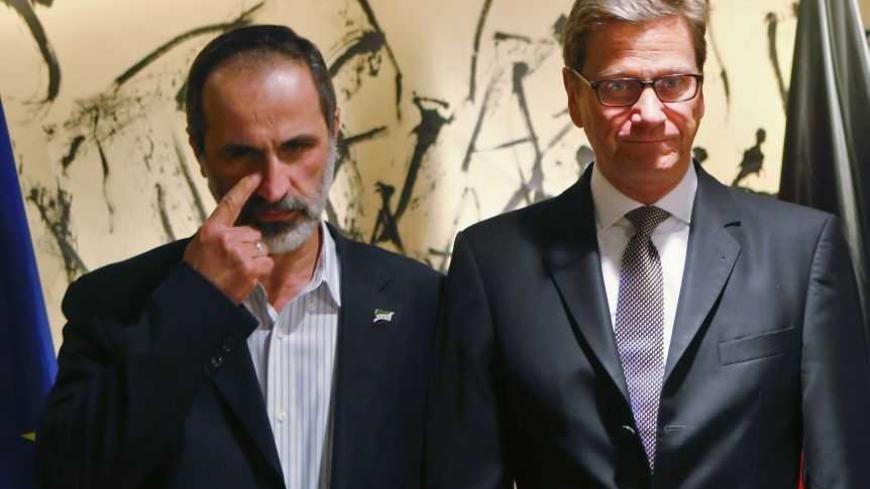 German Foreign Minister Guido Westerwelle and Sheikh Moaz Al-Khatib, President of the National Coalition of Syrian Revolutionary and Opposition Forces (L) arrive for bilateral talks at the 49th Conference on Security Policy, in Munich February 1, 2013. World leaders including U.S. Vice President Joe Biden, NATO Secretary General Anders Fogh Rasmussen and Spain's Foreign Minister Jose Manuel Garcia-Margallo are due to participate in the security conference on Sunday. REUTERS/Michael Dalder (GERMANY - Tags: M