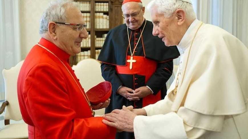 Pope Benedict XVI (R) meets in a private audience with Louis Raphael I Sako (L), the Chaldean Catholic Patriarch of Babylon and the Head of the Chaldean Catholic Church, in Vatican February 4, 2013 in this picture provided by Osservatore Romano. 
REUTERS/Osservatore Romano/Handout (VATICAN - Tags: RELIGION)
ATTENTION EDITORS - THIS IMAGE WAS PROVIDED BY A THIRD PARTY. FOR EDITORIAL USE ONLY. NOT FOR SALE FOR MARKETING OR ADVERTISING CAMPAIGNS. THIS PICTURE IS DISTRIBUTED EXACTLY AS RECEIVED BY REUTERS, AS A
