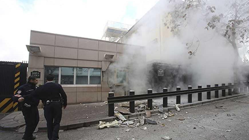 ATTENTION EDITORS - VISUAL COVERAGE OF SCENES OF INJURY OR DEATH
Turkish police officers react after an explosion at the entrance of the U.S. Embassy in Ankara February 1, 2013 in this picture provided by Milliyet Daily Newspaper. A suicide bomber killed a Turkish security guard (not pictured) at the U.S. embassy in Ankara on Friday, blowing the door off a side entrance and sending smoke and debris flying into the street. Ankara Governor Alaaddin Yuksel said the attacker was inside U.S. property when the ex