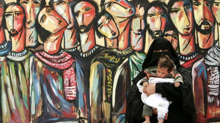 Palestinian woman attends a protest calling for the release of Palestinian prisoners from Israeli jails, in Gaza April 16, 2007. REUTERS/Mohammed Salem (GAZA) - RTR1OOS7
